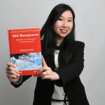 Veronique Duong holding her book about SEO management